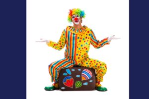 Is it safe? An unsure clown sitting on a suitcase