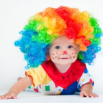 Crawling baby dressed as a clown