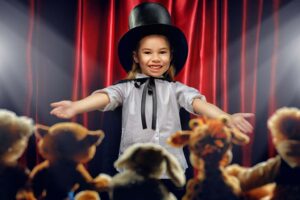 A kid putting on a circus for her stuffed animals