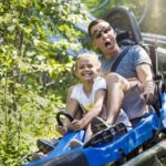 father and daugther on a roller coaster